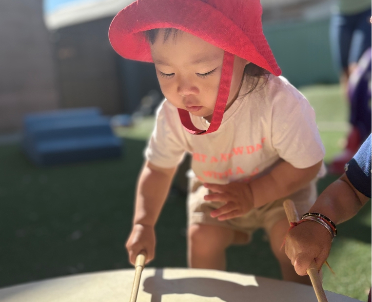 Infant exploring outdoors at ABC Day Nursery